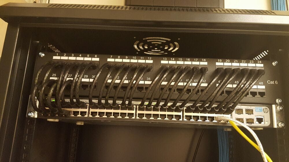 48-port patch panel terminated in a wall cabinet