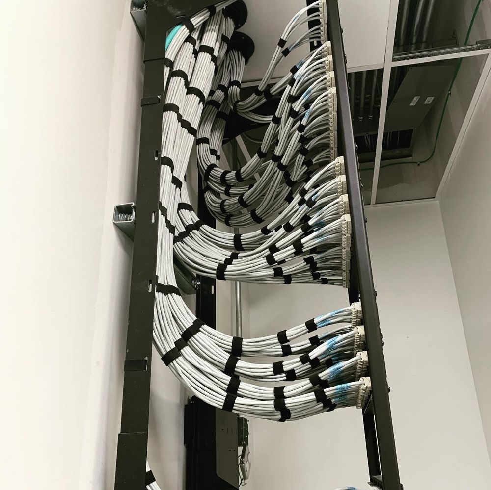 Cable bundles on ladder rack above a network rack