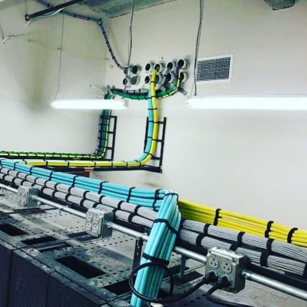 Cat6 and fiber runs on ladder rack in a telecom room